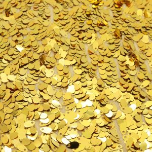 Stretchstoff mit goldenen Pailletten