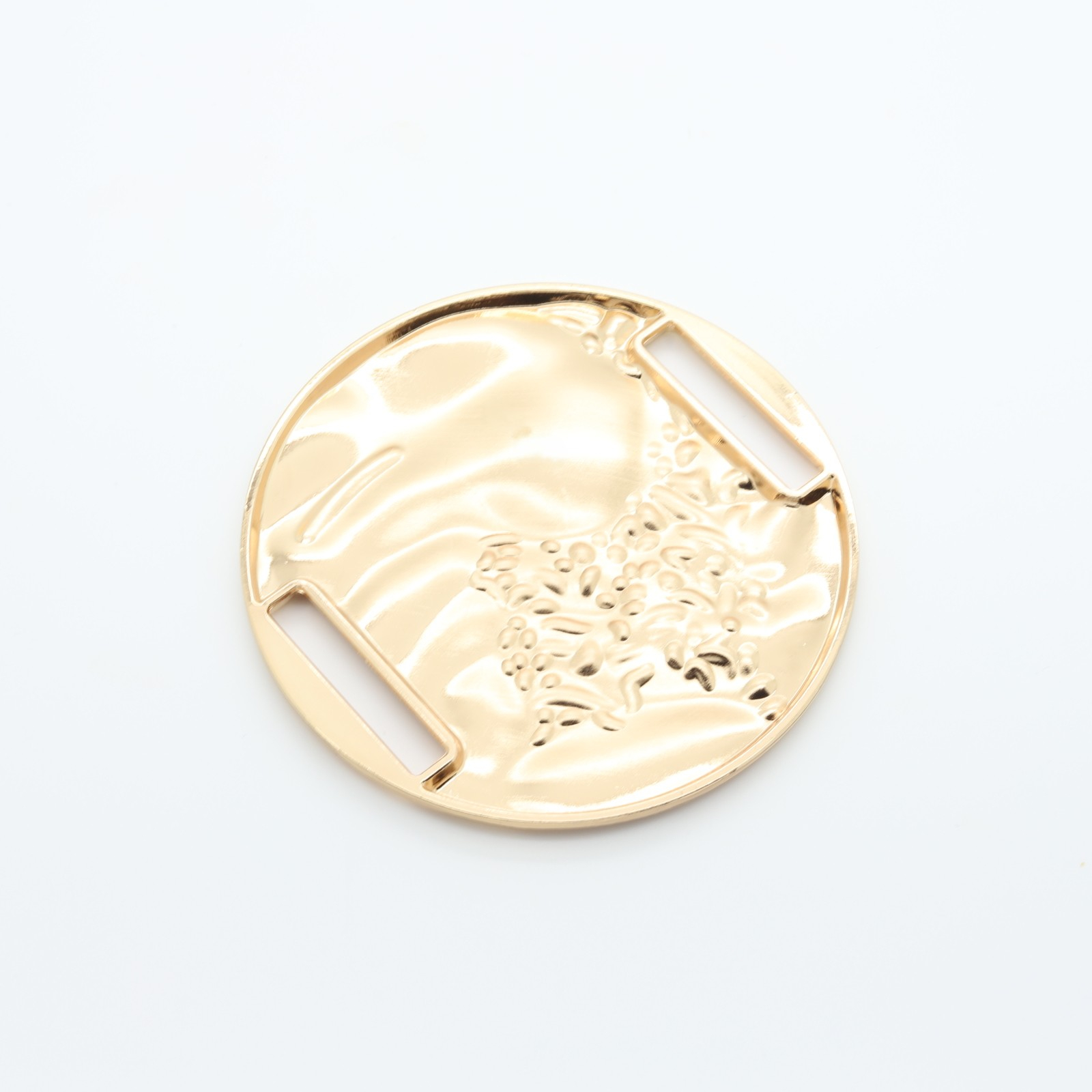 Large round gilded metal loop with relief structure