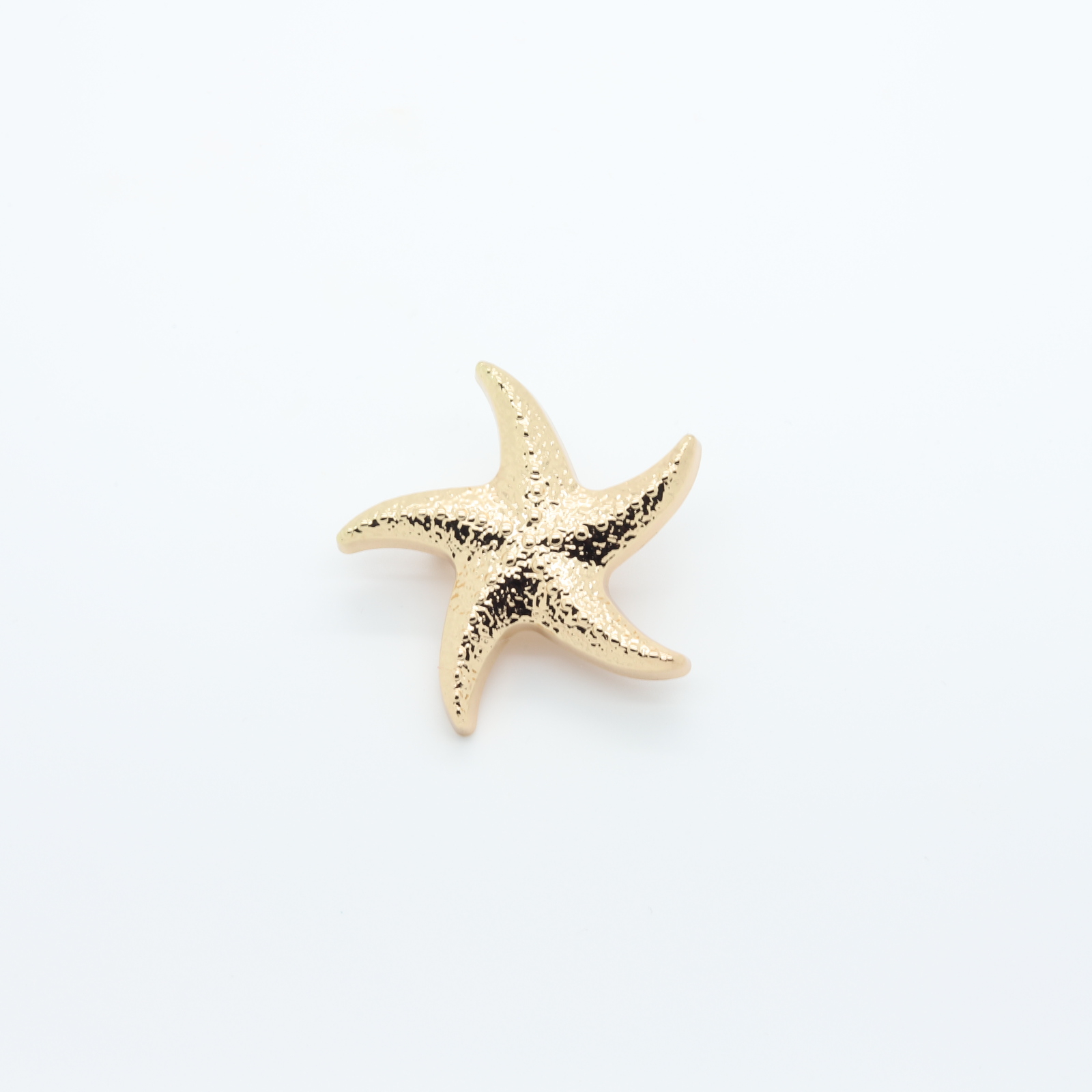 Gold-plated star-shaped bikini pin