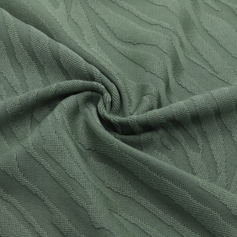 Tessuto jacquard verde con motivo in rilievo